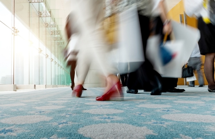 Feet of office workers stepping on a carpet in the workplace